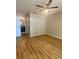 Spacious bedroom featuring wood floors, ceiling fan, and access to the bathroom at 4639 Cabbage Palm Dr, Valrico, FL 33596