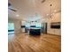 Modern kitchen with stainless steel appliances, island with seating, and hardwood floors at 4639 Cabbage Palm Dr, Valrico, FL 33596