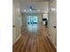 Bright living room featuring hardwood floors, neutral paint, recessed lighting, and access to the kitchen at 4639 Cabbage Palm Dr, Valrico, FL 33596