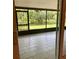The screened porch offers tiled flooring and views of the backyard and serene pond at 4639 Cabbage Palm Dr, Valrico, FL 33596