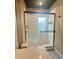 Bathroom shower features white tiles, black trim, and a window at 4639 Cabbage Palm Dr, Valrico, FL 33596