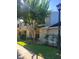 Exterior view of the townhouse with a manicured lawn and lush landscaping at 5100 Burchette Rd # 1304, Tampa, FL 33647