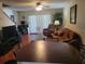 Inviting living room with hardwood floors, a ceiling fan, a brown sofa, and sliding doors at 5100 Burchette Rd # 1304, Tampa, FL 33647