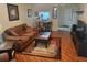 Cozy living room with hardwood floors, a comfortable brown sofa, and a dining area at 5100 Burchette Rd # 1304, Tampa, FL 33647