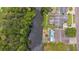 Aerial view of a home on a canal with a pool and lush greenery surrounding the backyard at 516 7Th Se St, Largo, FL 33771