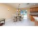 Cozy dining area features a chandelier and sliding glass doors to the pool area at 516 7Th Se St, Largo, FL 33771