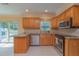 Bright kitchen features wood cabinetry, stainless steel appliances and sliding glass doors to outdoor living area at 516 7Th Se St, Largo, FL 33771