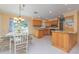 Modern kitchen featuring wood cabinets, granite countertops, stainless steel appliances, and tile flooring at 516 7Th Se St, Largo, FL 33771