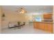 Open-concept living area with tile floors, neutral walls, ceiling fan, and an adjacent dining area at 516 7Th Se St, Largo, FL 33771