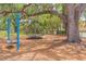 Charming community playground shaded by mature oak trees with a swing set and jungle gym at 516 7Th Se St, Largo, FL 33771