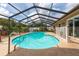 Backyard pool featuring a screen enclosure, landscaped yard, and outdoor furniture at 516 7Th Se St, Largo, FL 33771