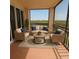 Relaxing screened balcony with water views, complete with seating and a coffee table at 5430 Eagles Point Cir # 202, Sarasota, FL 34231