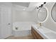Bathroom with a jacuzzi tub, light wood vanity, backlit mirror, and modern fixtures at 5430 Eagles Point Cir # 202, Sarasota, FL 34231