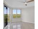 Bedroom featuring tile floors, a ceiling fan, and a sliding glass door to a balcony at 5430 Eagles Point Cir # 202, Sarasota, FL 34231