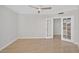 Bright bedroom featuring tile floors, a ceiling fan, and a glass-paned door at 5430 Eagles Point Cir # 202, Sarasota, FL 34231