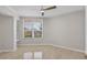 Bedroom with a ceiling fan, window and neutral colored flooring at 5430 Eagles Point Cir # 202, Sarasota, FL 34231