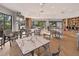 Inviting common area with tables, chairs, large windows, and well-stocked bookshelves at 5430 Eagles Point Cir # 202, Sarasota, FL 34231
