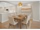 Dining room has a wooden table with six chairs, with art hanging on the wall at 5430 Eagles Point Cir # 202, Sarasota, FL 34231