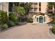 Well maintained building entry with covered entrance and attractive landscaping at 5430 Eagles Point Cir # 202, Sarasota, FL 34231
