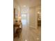 Bright hallway featuring tile flooring, neutral walls, and access to a half-bath with modern fixtures at 5430 Eagles Point Cir # 202, Sarasota, FL 34231