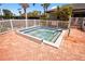 Community hot tub surrounded by lush landscaping and a white picket fence at 5430 Eagles Point Cir # 202, Sarasota, FL 34231