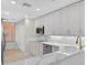 Well-lit kitchen featuring marble countertops, white cabinetry, stainless steel appliances, and a window view at 5430 Eagles Point Cir # 202, Sarasota, FL 34231