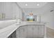 Modern white kitchen features marble countertops, updated appliances, and a breakfast bar overlooking a view at 5430 Eagles Point Cir # 202, Sarasota, FL 34231
