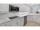 Modern kitchen with white cabinetry, marble countertops, stainless steel appliances, and lots of natural light at 5430 Eagles Point Cir # 202, Sarasota, FL 34231