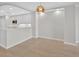 Open-concept kitchen features modern white cabinets and a breakfast bar with stylish gold fixtures at 5430 Eagles Point Cir # 202, Sarasota, FL 34231