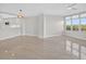 Spacious living area with tan tile floors, recessed lighting, and natural light from the windows at 5430 Eagles Point Cir # 202, Sarasota, FL 34231