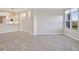 Inviting living space with a large window, neutral walls, and a modern kitchen in background at 5430 Eagles Point Cir # 202, Sarasota, FL 34231