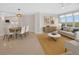 Open-concept living space features a dining table, sofa, credenza and views of the water at 5430 Eagles Point Cir # 202, Sarasota, FL 34231
