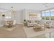 Living space with a beige sofa, round wood table and views of the water at 5430 Eagles Point Cir # 202, Sarasota, FL 34231