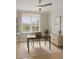 Bright office with a dark desk and chair, blinds on the window and natural light at 5430 Eagles Point Cir # 202, Sarasota, FL 34231