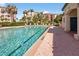 Community pool with crystal clear water and lounge chairs, next to amenities at 5430 Eagles Point Cir # 202, Sarasota, FL 34231
