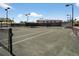 Well-maintained tennis court with professional nets, surrounded by lighting at 5430 Eagles Point Cir # 202, Sarasota, FL 34231