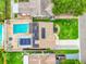Aerial view of a home with a solar panel roof, pool, and landscaped backyard at 5726 20Th N Ave, St Petersburg, FL 33710