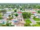 Aerial view displays a home with solar panels, swimming pool and well-maintained landscaping at 5726 20Th N Ave, St Petersburg, FL 33710