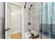 Bathroom featuring a shower/tub, tile surround, and blue and white shower curtain at 5726 20Th N Ave, St Petersburg, FL 33710