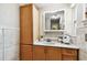 Bathroom features a tile surround, wood cabinets, and vanity at 5726 20Th N Ave, St Petersburg, FL 33710