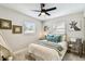Cozy bedroom featuring a bed with decorative pillows and a ceiling fan, complemented by unique wall art at 5726 20Th N Ave, St Petersburg, FL 33710