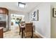 Dining area with wicker chairs, tile flooring, and view into the living room at 5726 20Th N Ave, St Petersburg, FL 33710