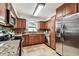 Well-lit kitchen featuring stainless steel appliances, granite countertops, and wood cabinetry at 5726 20Th N Ave, St Petersburg, FL 33710
