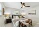 Comfortable bedroom with neutral tones, ceiling fan, bench, and natural light at 5726 20Th N Ave, St Petersburg, FL 33710