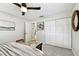 Bedroom with closet space, ceiling fan, and travertine flooring in attached hall at 5726 20Th N Ave, St Petersburg, FL 33710