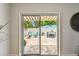 View through sliding glass doors to a brick-paved patio with outdoor furniture and a comfortable seating area at 5726 20Th N Ave, St Petersburg, FL 33710