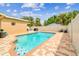 Relax by the pool surrounded by a fenced yard, lush greenery, and blue skies at 5726 20Th N Ave, St Petersburg, FL 33710