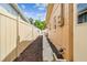 Fenced side yard with mulch landscaping and exterior home details, offering privacy at 5726 20Th N Ave, St Petersburg, FL 33710