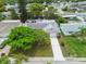 Aerial view of a home with a well-maintained lawn, lush landscaping, and a welcoming facade at 5744 Thrush Dr, New Port Richey, FL 34652