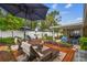 Inviting backyard with lounge chairs, dining set, lush plantings, and private fencing at 5744 Thrush Dr, New Port Richey, FL 34652